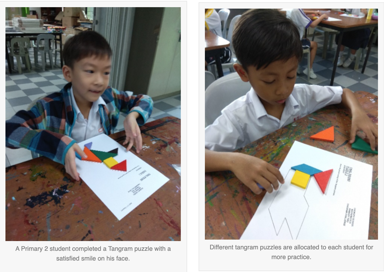 Two young boys at school desks arrange colorful tangram puzzle pieces on white paper sheets.